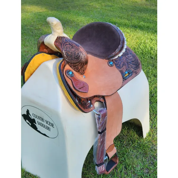 14", 15", 16" Double T barrel saddle with silver laced tan rawhide cantle, dot border on rough out fenders and jockeys.